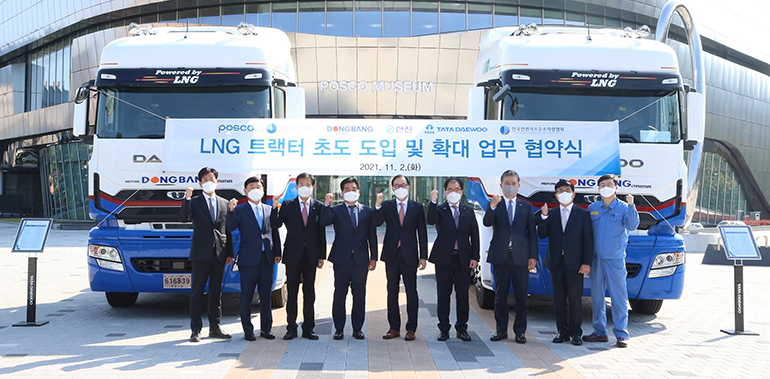 LNG 화물차 보급 협력 MOU를 맺은 관계자들이 파이팅을 외치고 있다. 오른쪽부터 세 번째 김방신 타타대우 사장, 여섯 번째 김정우 타타대우상용차판매 대표이사