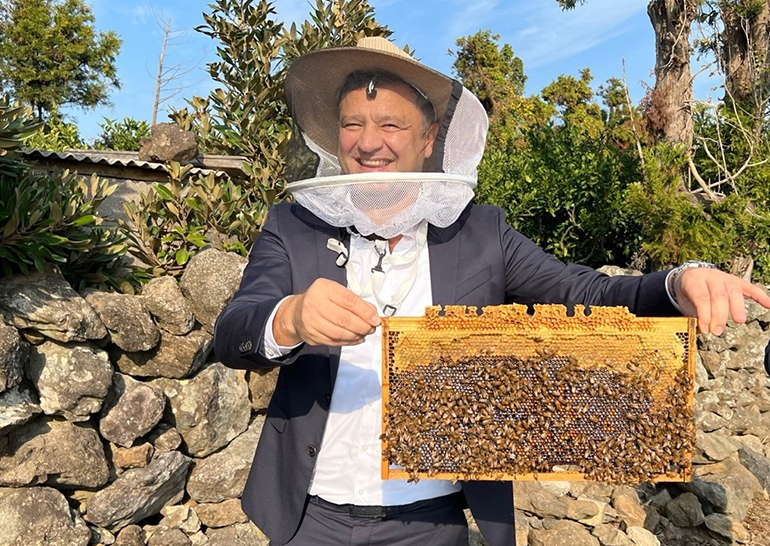 꿀벌 밀랍을 들고 환하게 웃고 있는 안토니오 란다조 다임러트럭코리아 대표이사.